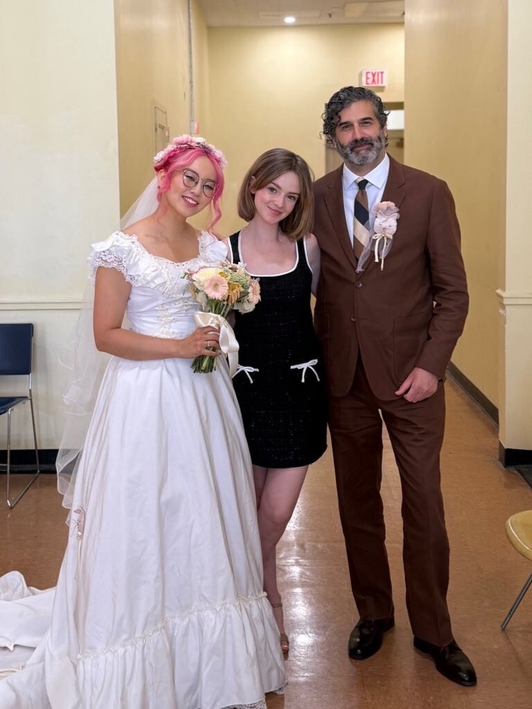 Madison Campbell wearing a black dress with guests at a celebration